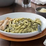 Creamy Spinach Sauce on pasta in a white dish