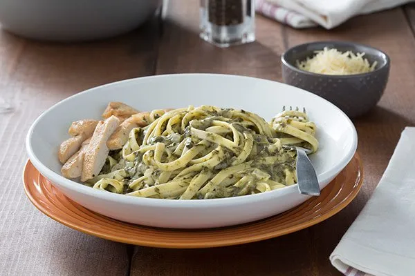 Creamy Spinach Sauce on pasta in a white dish